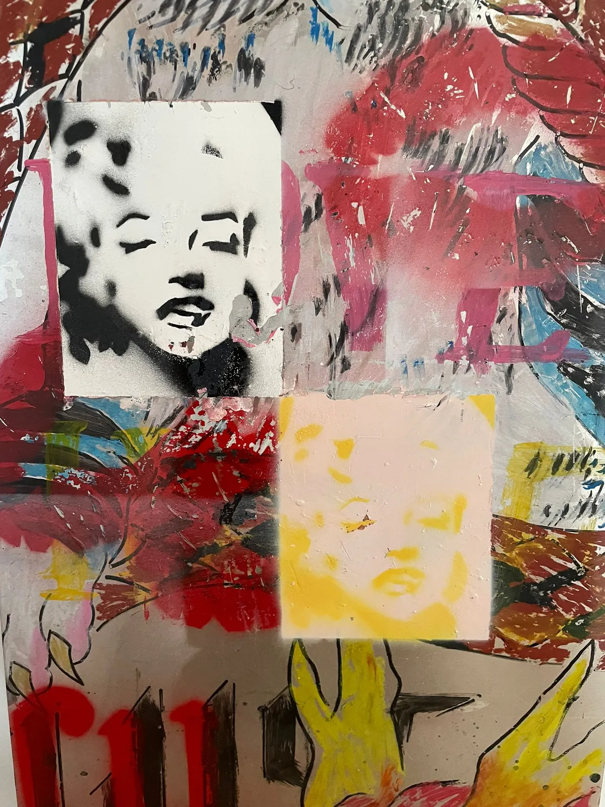 Detail of the panel's top edge: two taped rectangles carrying stencilled portraits of Marilyn Monroe, one in black and white, one in yellow, over red and blue scribbled marks.